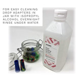 Bottle of Solimo ethyl rubbing alcohol beside jar of adapters for Xlarge Weed Pipes Smoke Blocker